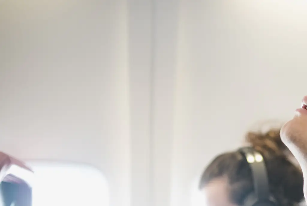 Sleeping on a plane can be tricky for some travelers. Credit: SolStock/Getty