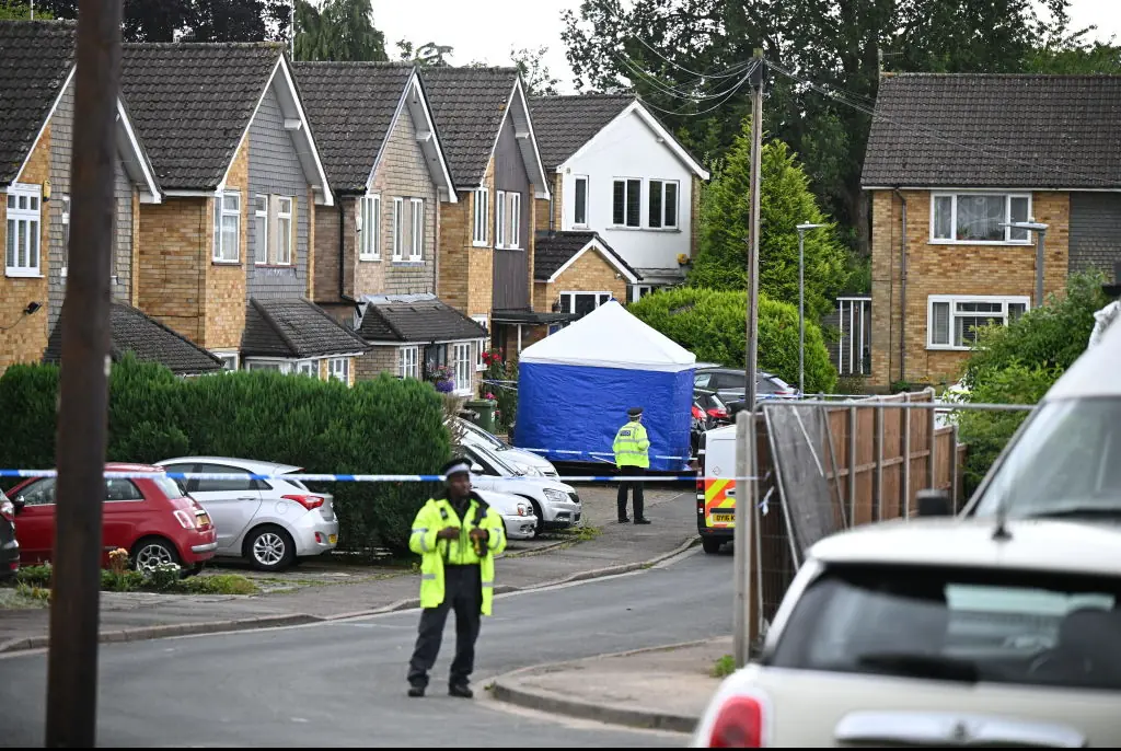Police outside the home where the killings took place. Credit: Leon Neal / Getty