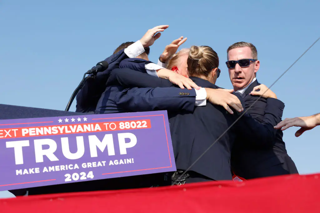 Donald Trump rushed off stage bleeding after gun attack at rally