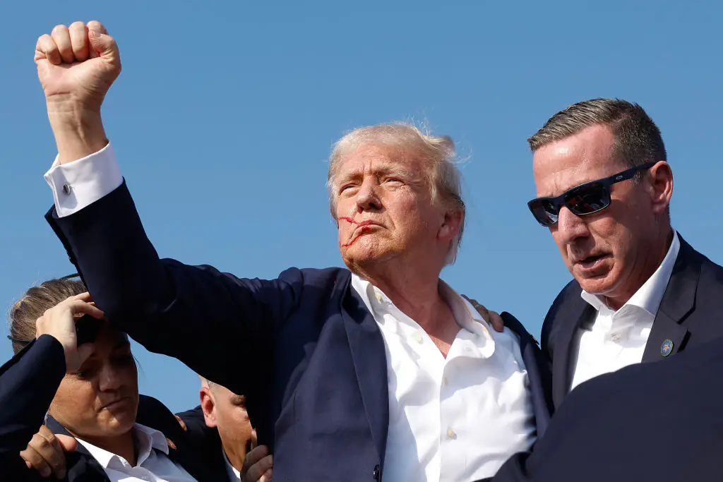 Donald Trump pumps his fist as he is rushed offstage during the rally in Butler. Credit: Anna Moneymaker/Getty