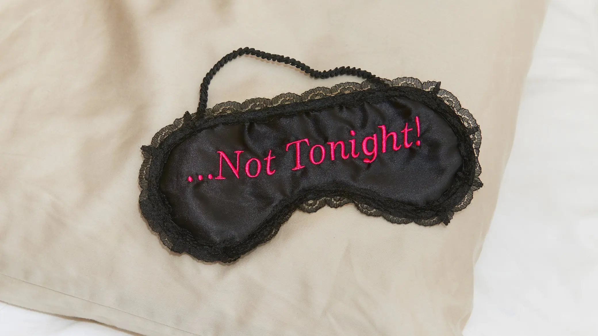 A sleep mask with the words, 'not tonight' written on it