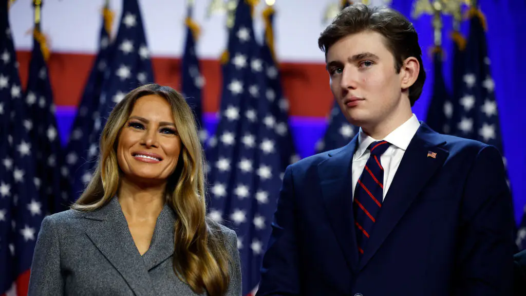 WEST PALM BEACH, FLORIDA - NOVEMBER 06: Former first lady Melania Trump and Barron Trump look on as Republican presidential nominee, former U.S. President Donald Trump speaks during an election night event at the Palm Beach Convention Center on November 06, 2024 in West Palm Beach, Florida. Americans cast their ballots today in the presidential race between Republican nominee former President Donald Trump and Vice President Kamala Harris, as well as multiple state elections that will determine the balance of power in Congress. (Photo by Chip Somodevilla/Getty Images)