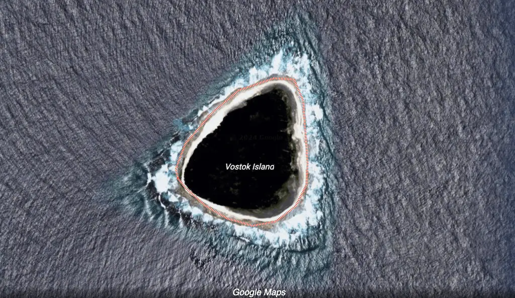 Vostok Island has prompted conspiracy theories on social media, with many questioning whether there is a particular reason why Google Maps has blurred out and blackened out the middle of the island. Credit: Google Maps