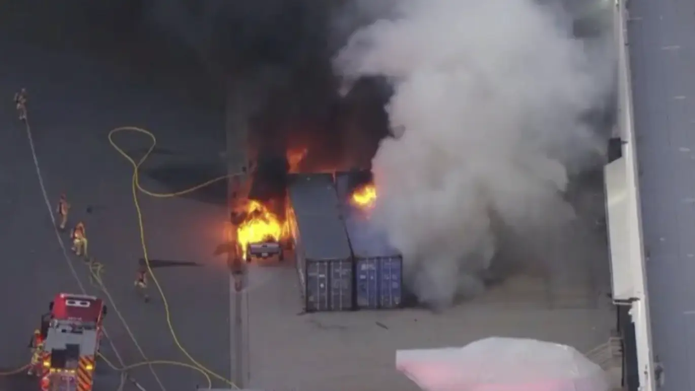 The helicopter's wreckage caught ablaze in Los Angeles. Credit: CBS