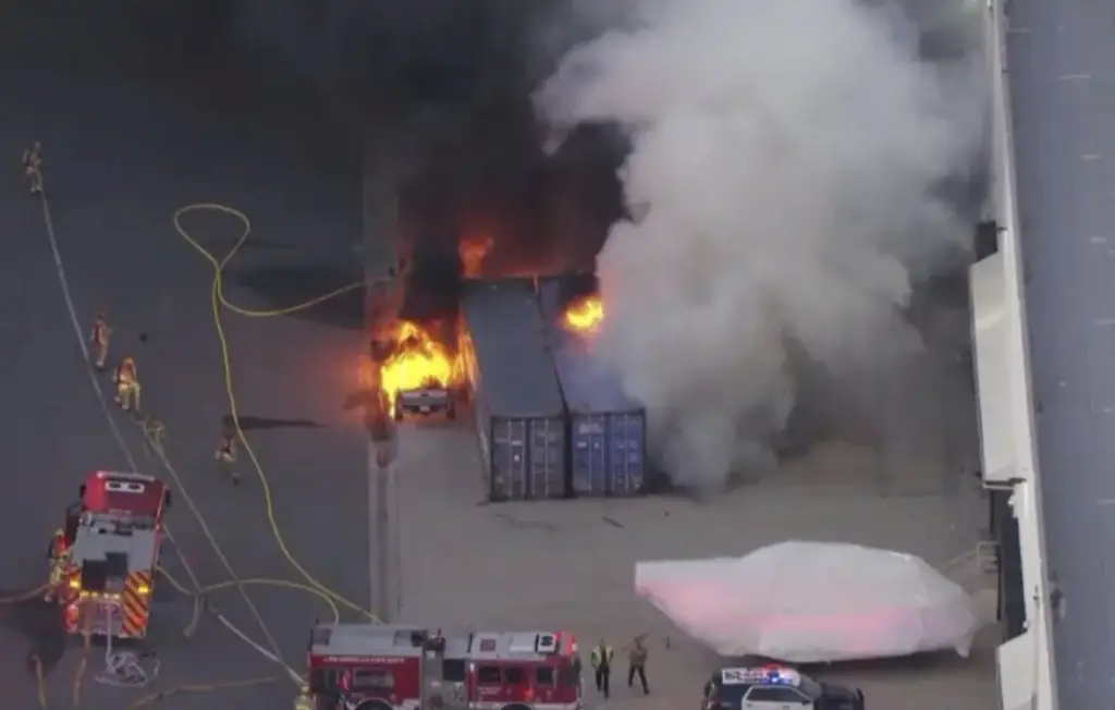 The helicopter's wreckage caught ablaze in Los Angeles. Credit: CBS