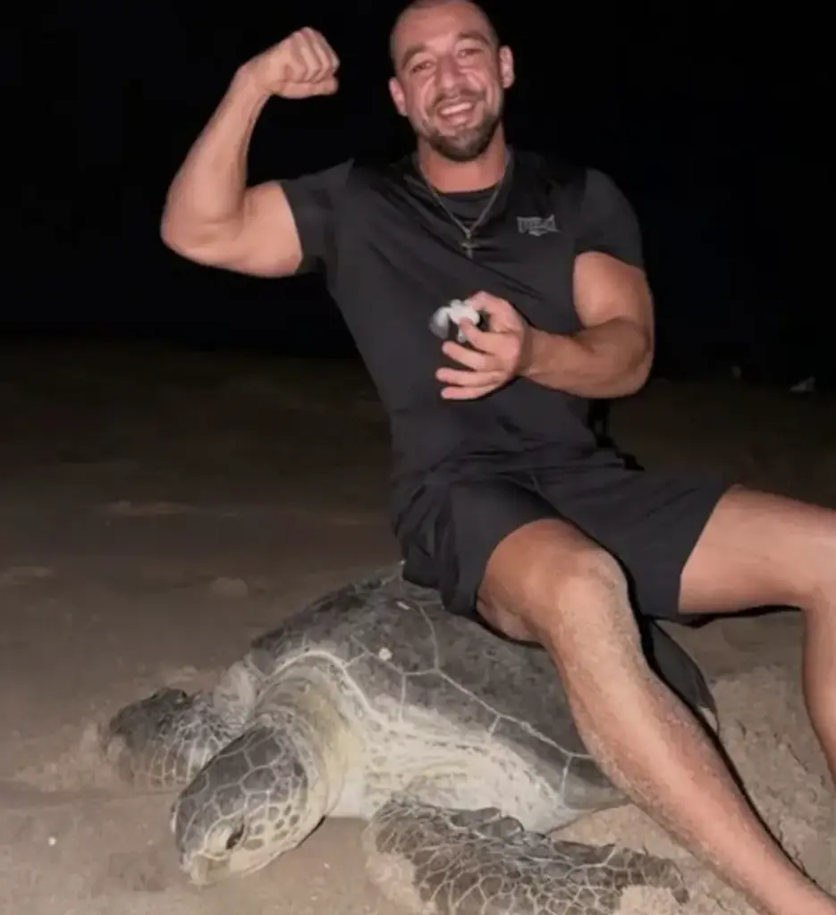 Vadym Oleynik, an influencer, has prompoted outrage after being picture sitting on a turtle in Oman. Credit: Vadym Oleynik/Instagram